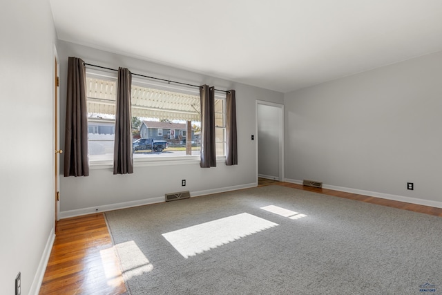 unfurnished room with wood-type flooring