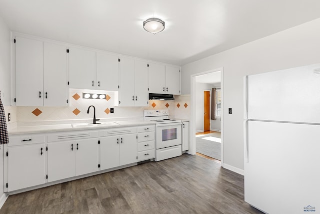 kitchen with white appliances, sink, hardwood / wood-style flooring, and white cabinets