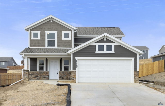 craftsman inspired home with covered porch, roof with shingles, driveway, and fence