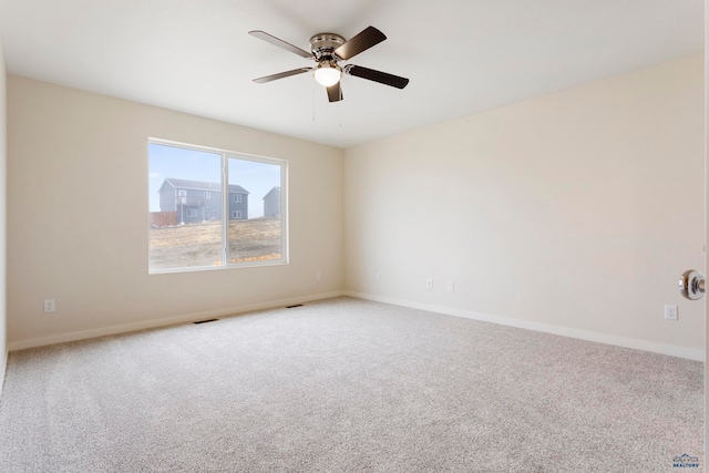 unfurnished room featuring a ceiling fan, carpet flooring, visible vents, and baseboards