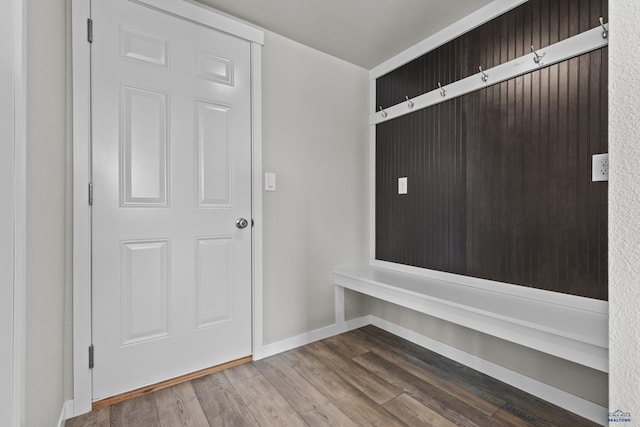 mudroom with wood finished floors and baseboards