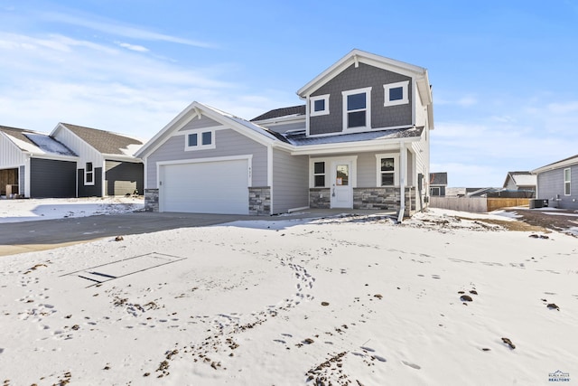 view of front of house featuring stone siding, fence, a garage, and a porch