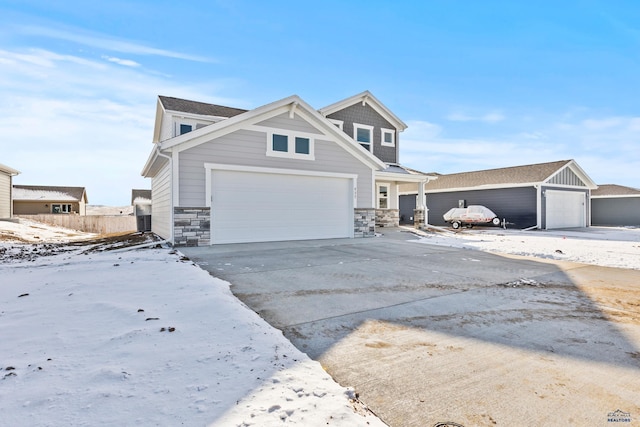 view of front of house with stone siding, an attached garage, and concrete driveway