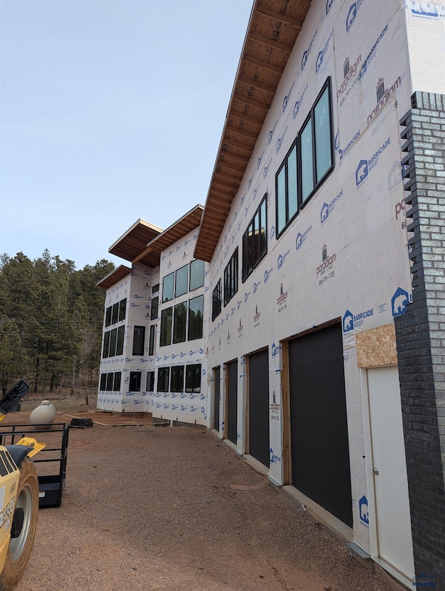24406 Oak Meadows Rd, Keystone, SD 57751 - view of building exterior featuring an attached garage and driveway