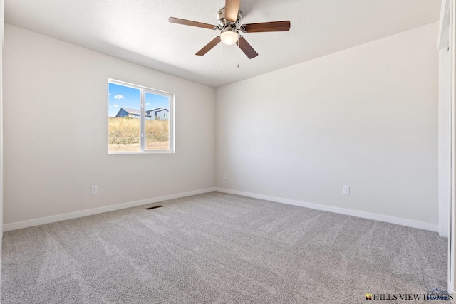 empty room featuring ceiling fan and carpet flooring