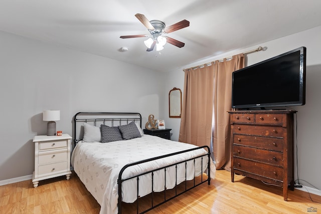 bedroom with ceiling fan and light hardwood / wood-style flooring