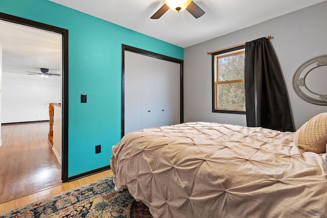 bedroom with hardwood / wood-style floors, ceiling fan, and a closet