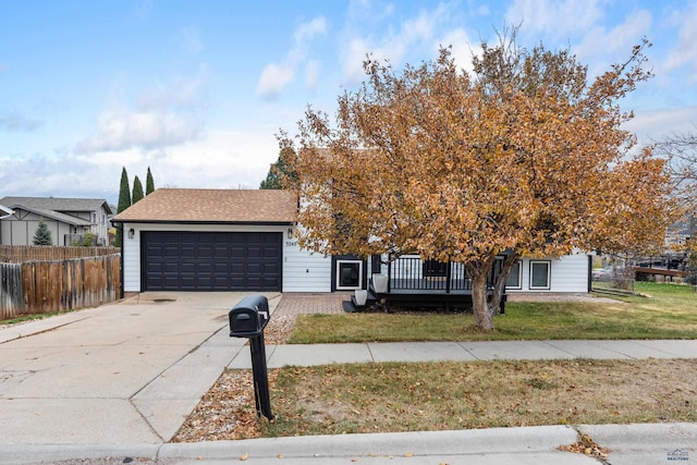 view of front of property with a garage, a wooden deck, and a front lawn