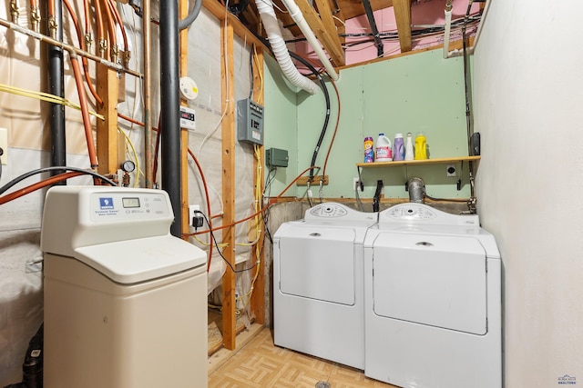 laundry area with light parquet flooring and washing machine and clothes dryer