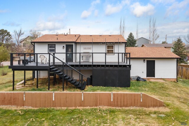 back of property with a wooden deck and a yard