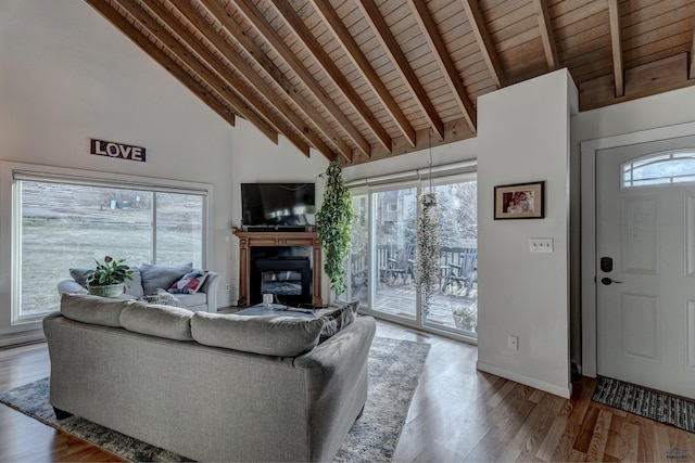 living room featuring beamed ceiling, light hardwood / wood-style flooring, high vaulted ceiling, and wood ceiling