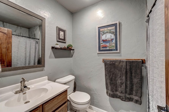 bathroom with vanity, a shower with shower curtain, and toilet