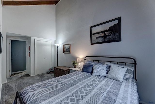 bedroom featuring carpet floors and a high ceiling