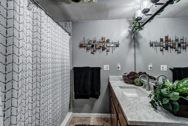 bathroom with curtained shower and vanity