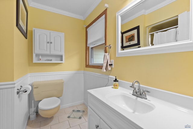 bathroom featuring toilet, tile patterned flooring, vanity, and ornamental molding