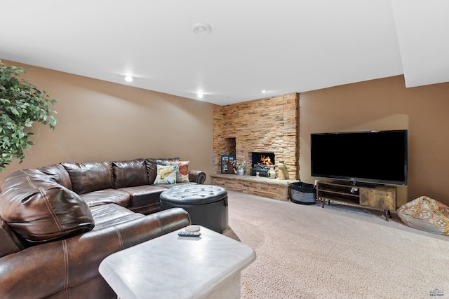 living room with carpet floors and a stone fireplace