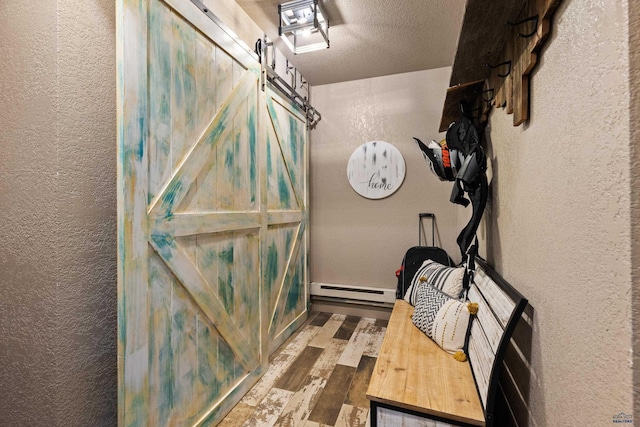 bathroom featuring a baseboard radiator, a textured ceiling, and hardwood / wood-style flooring