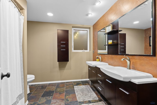 bathroom featuring vanity, tasteful backsplash, and toilet