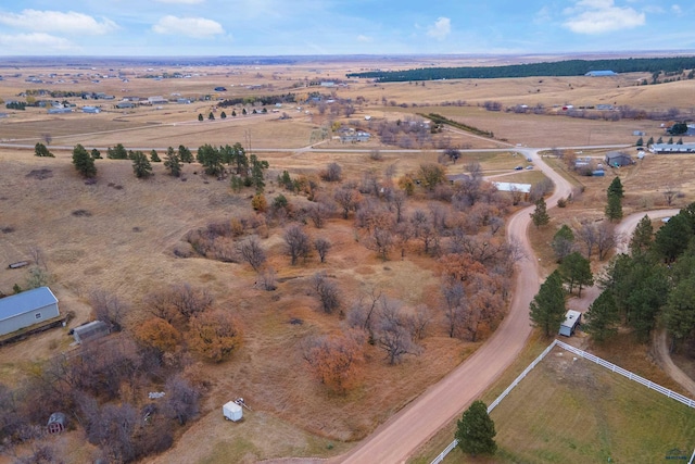 birds eye view of property with a rural view