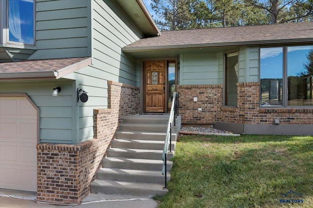 property entrance featuring a lawn and a garage