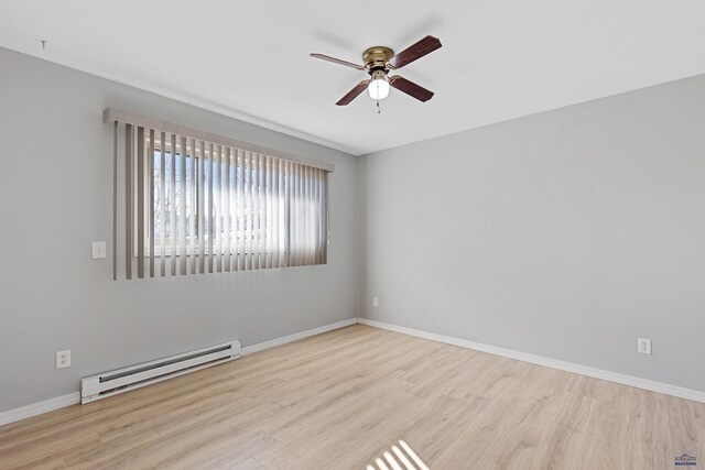 spare room with ceiling fan, light wood-type flooring, and a baseboard radiator