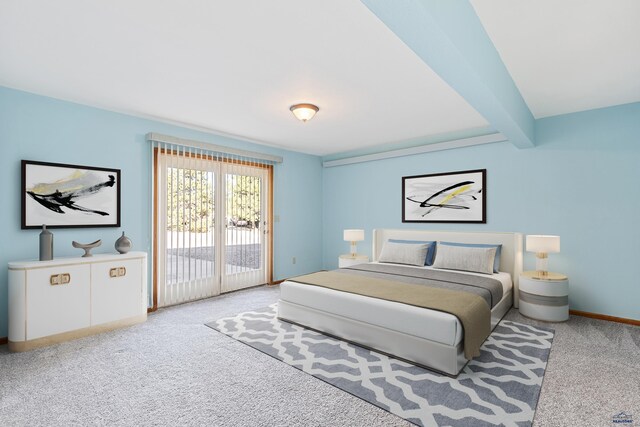 carpeted bedroom with beamed ceiling and access to outside