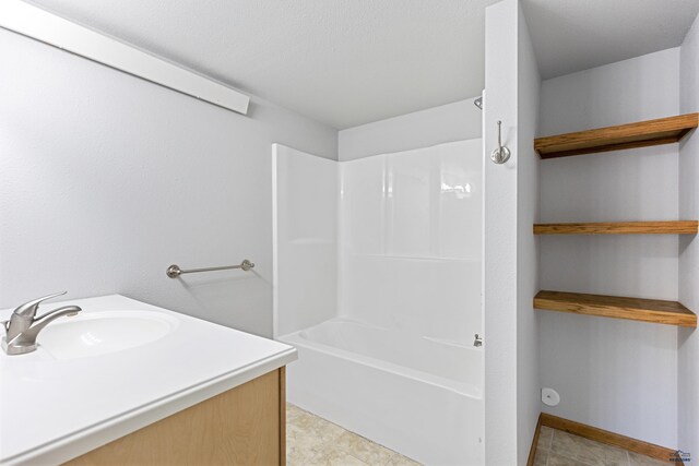 bathroom with bathing tub / shower combination, sink, and tile patterned flooring