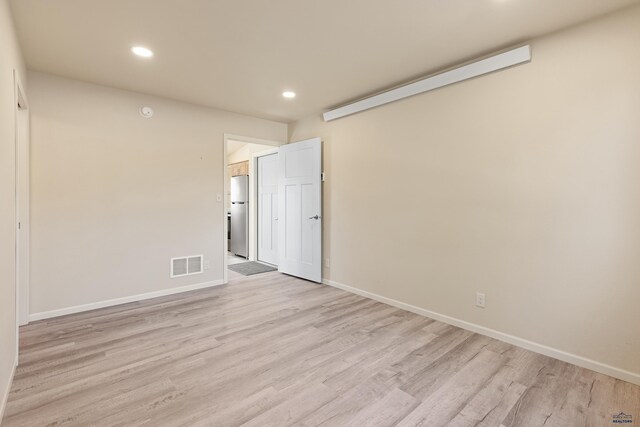 spare room featuring light hardwood / wood-style floors