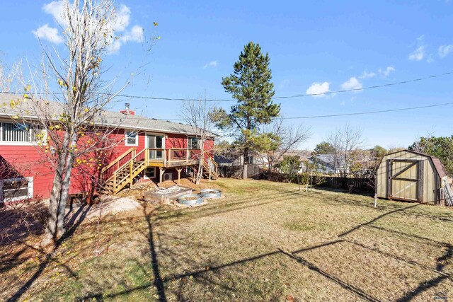 view of yard featuring a storage shed and a deck