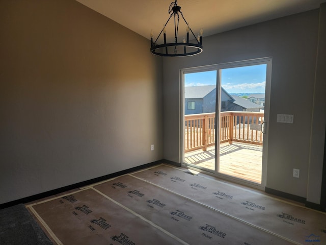 unfurnished dining area with carpet and a notable chandelier