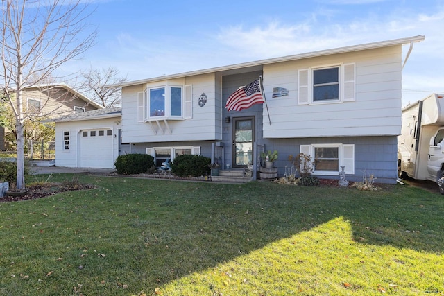 bi-level home with a front yard and a garage