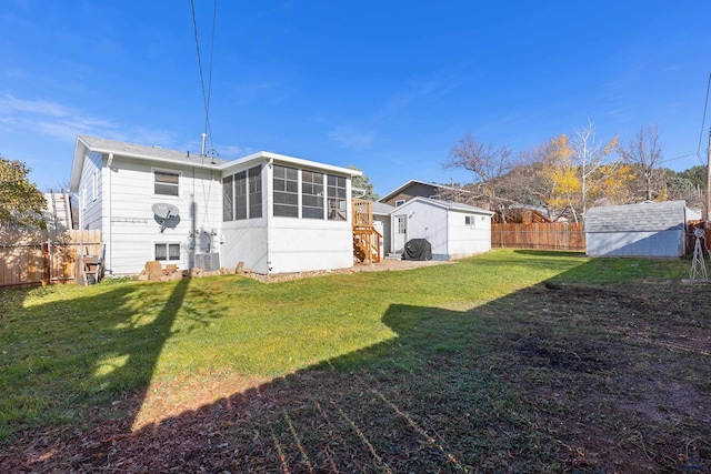 rear view of house featuring a lawn and a sunroom