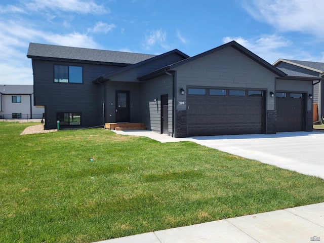 view of front of house with a front yard and a garage