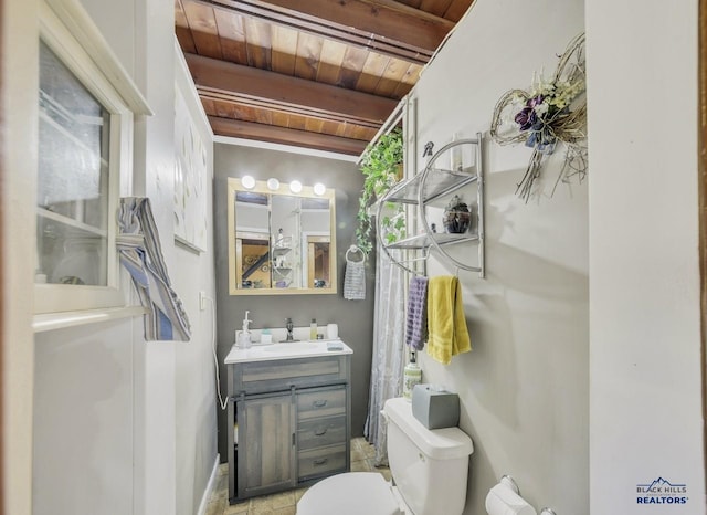 bathroom featuring beamed ceiling, vanity, toilet, and wooden ceiling