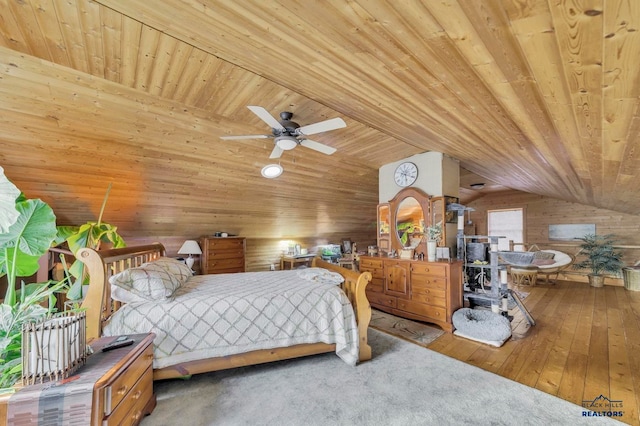 bedroom with wood ceiling, ceiling fan, wooden walls, carpet floors, and lofted ceiling