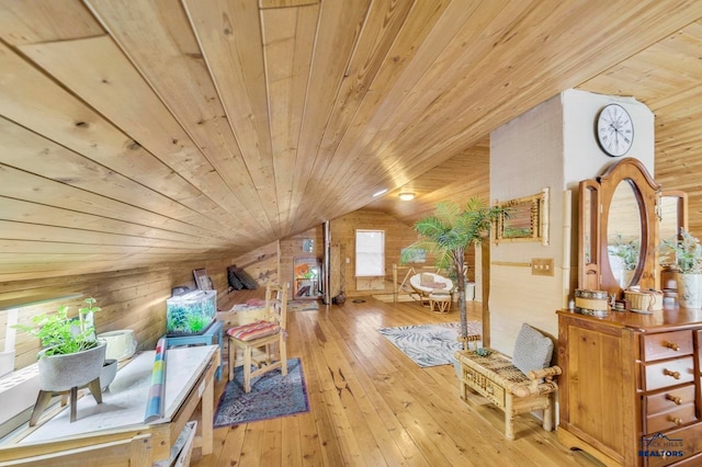 additional living space with wood-type flooring, wooden walls, lofted ceiling, and wood ceiling