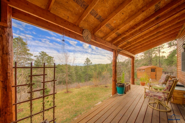 wooden deck featuring a shed