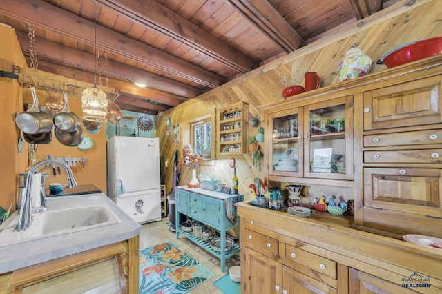 kitchen featuring wooden ceiling, sink, beamed ceiling, decorative light fixtures, and white fridge