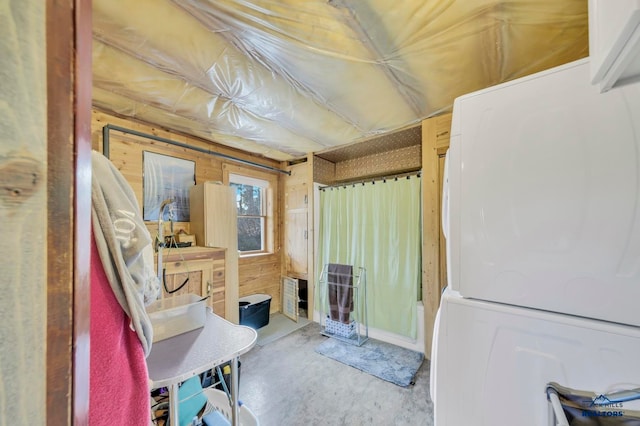 bathroom featuring concrete floors and wooden walls