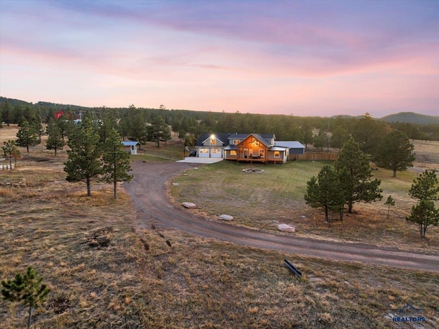 aerial view at dusk featuring a rural view