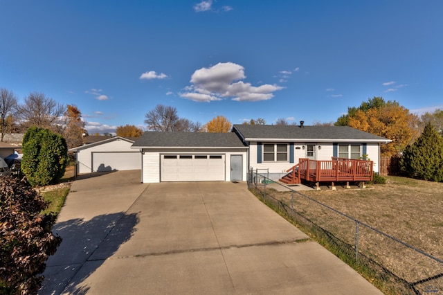 ranch-style house featuring a garage, a deck, and a front lawn