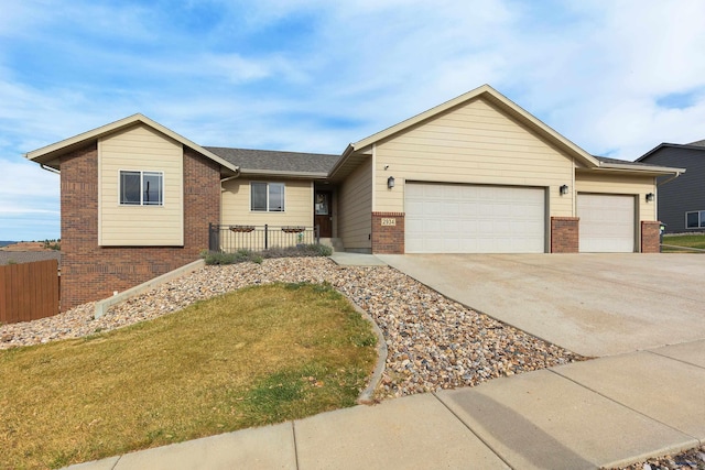 ranch-style home featuring a garage and a front lawn