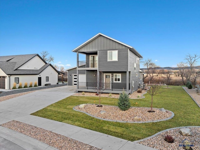 view of front of home featuring a front yard and a balcony