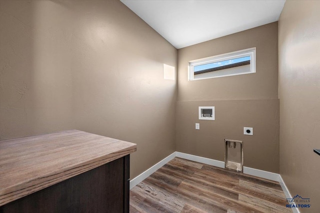 clothes washing area with hookup for an electric dryer, hookup for a washing machine, and hardwood / wood-style flooring