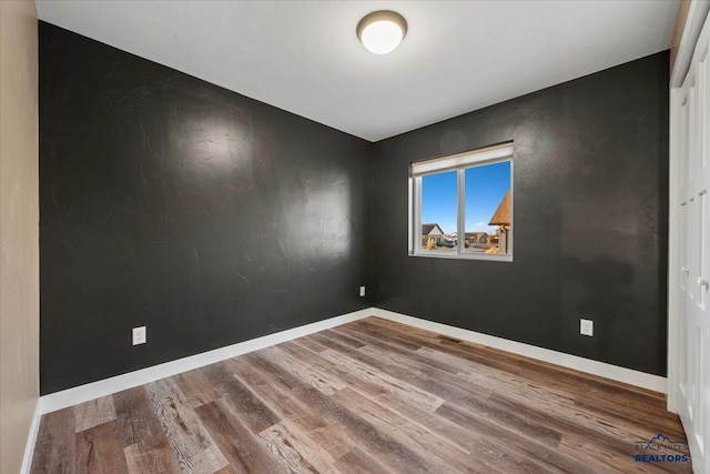 empty room featuring wood-type flooring