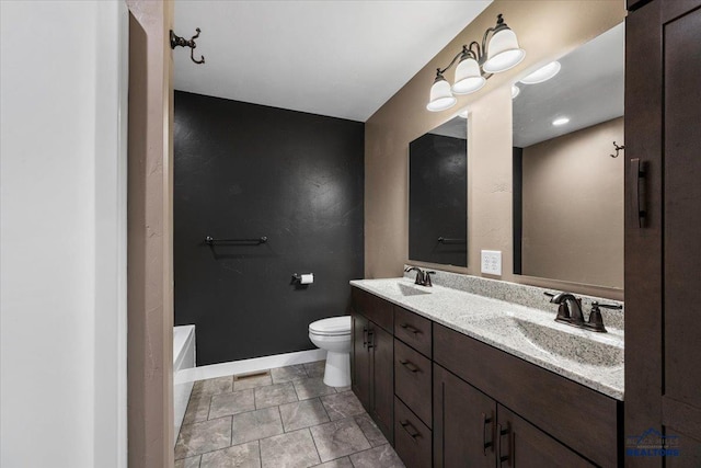 bathroom featuring tile patterned floors, vanity, toilet, and a tub to relax in