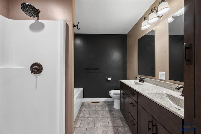 bathroom featuring tile patterned flooring, vanity, toilet, and a tub