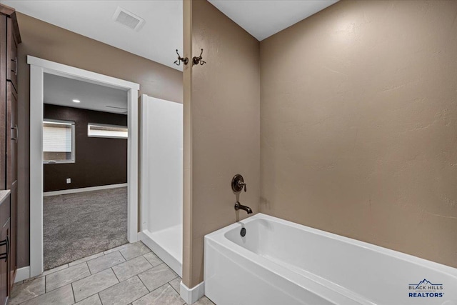 bathroom featuring separate shower and tub and tile patterned floors