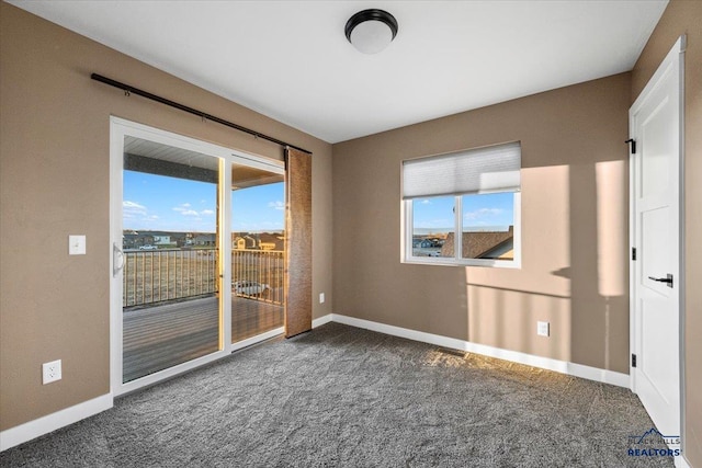 unfurnished room with dark colored carpet