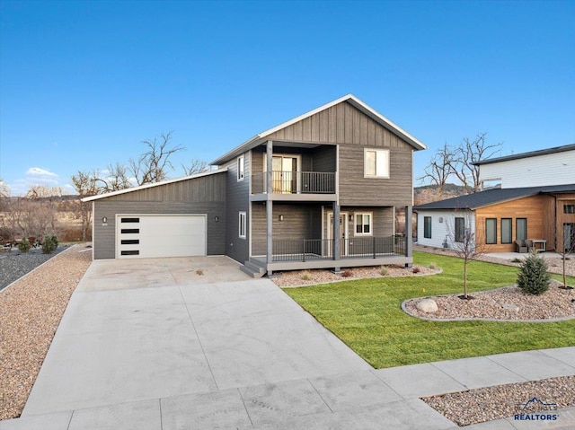 view of front of home featuring a balcony, a front lawn, and a garage